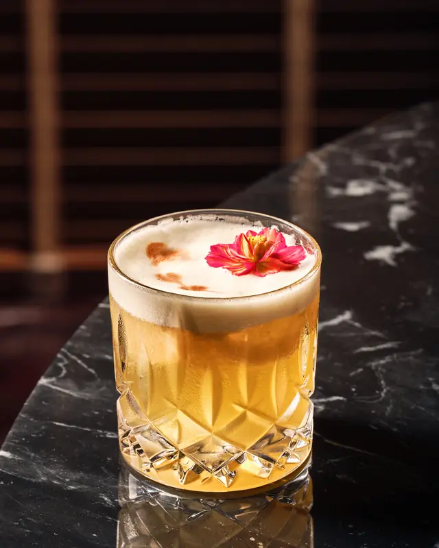 A lambanog sour in a cut-glass tumbler